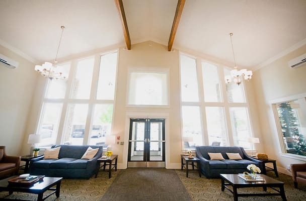 Bright, welcoming lobby with seating areas and large windows.