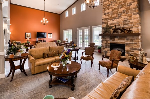 A spacious and inviting living room with comfortable seating and a stone fireplace.