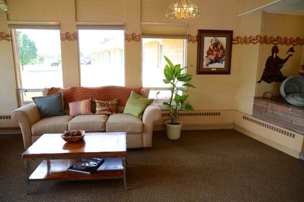 A comfortable living room space with a couch, coffee table, and decorative plant.