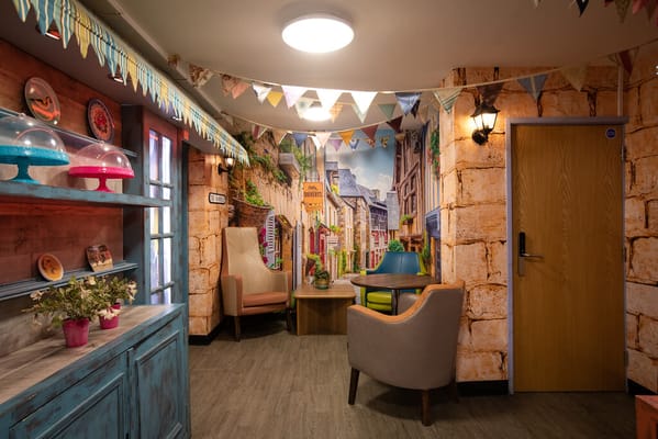 Colorful lounge area with seating and decorative wall