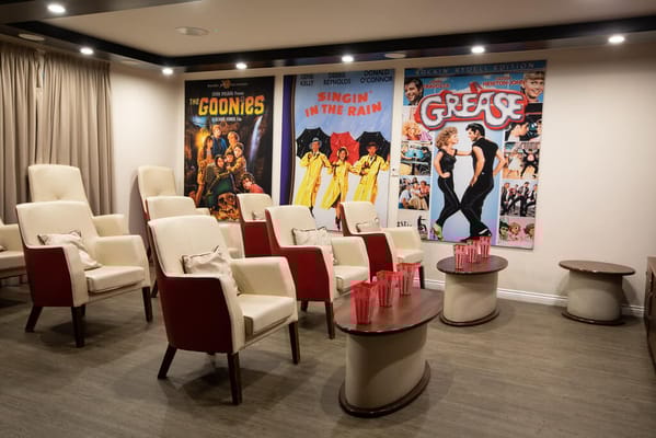 Cozy cinema room with red and white chairs and classic movie posters