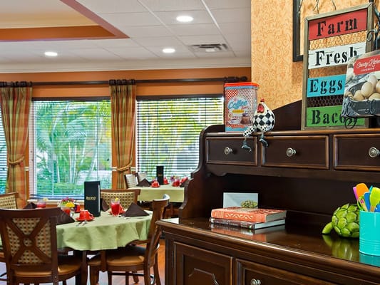 Cozy dining area with green tables and decorated windows