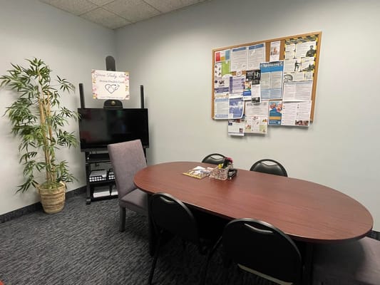 Meeting room with a round table and bulletin board