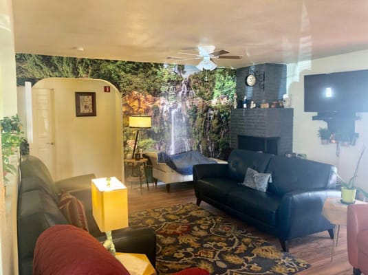 Comfortable common area with a nature mural