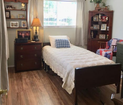 Bright private room with a bed and personal decor