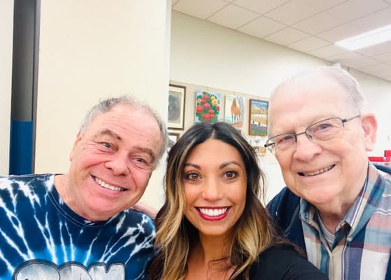 Residents smiling with staff member in common area