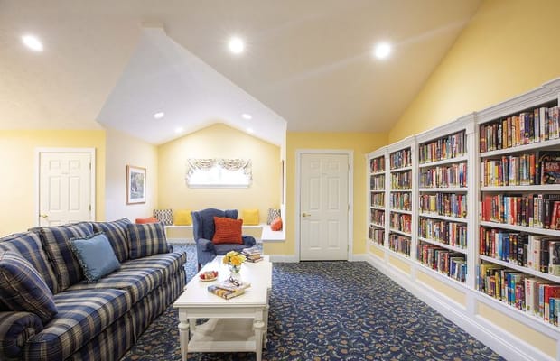 Inviting reading room with a sofa, bookshelf, and coffee table.