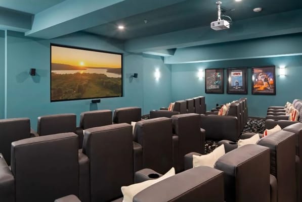 Cozy movie theater with reclining seats and large screen
