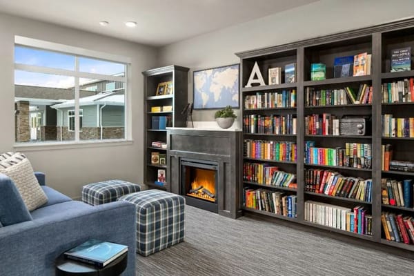 Cozy library area with bookshelves and comfortable seating