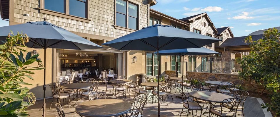 Outdoor patio area with tables and umbrellas