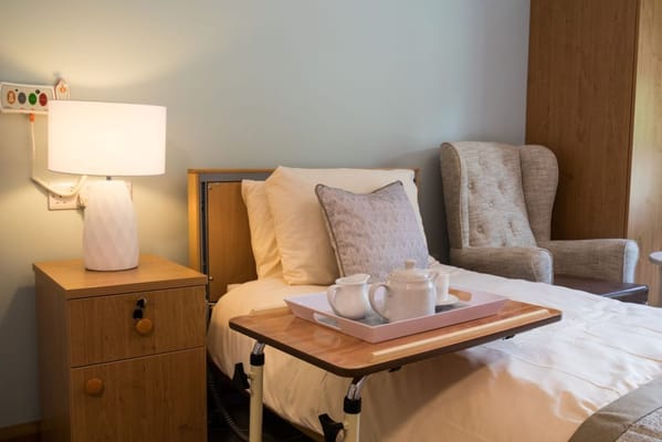 Cozy resident room with tea service and seating area