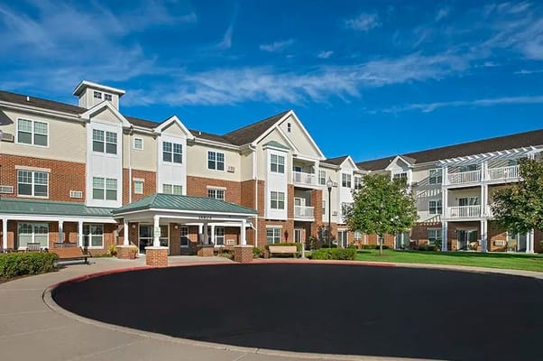 Exterior view of assisted living facility with gardens