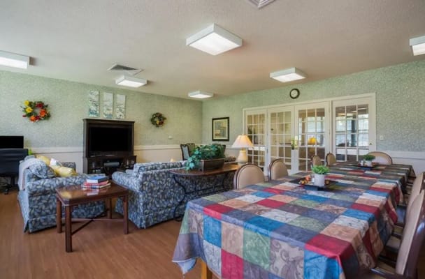 Bright common area with patterned tablecloth and floral decorations