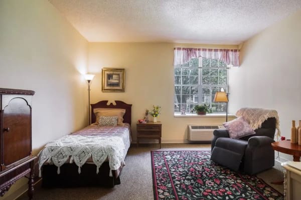 Cozy private room with bed and armchair