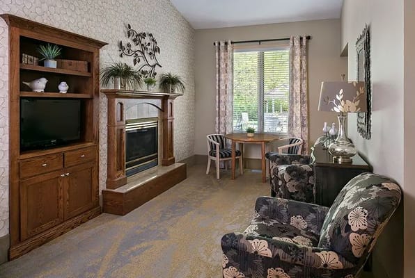 Cozy living room area with chairs and fireplace