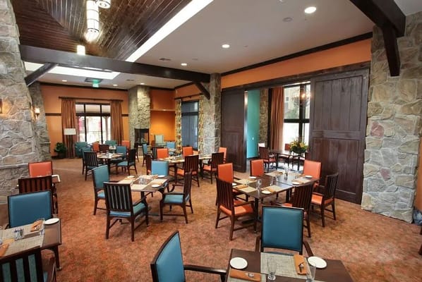 Bright dining room with tables and chairs set for meals
