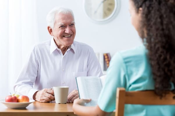 Senior resident enjoying coffee and conversation