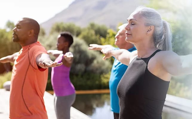 Group of people practicing yoga outdoors