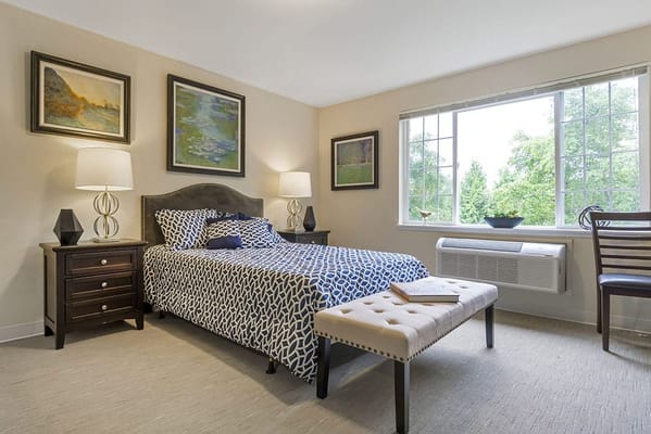 Cozy resident room with bed and artwork