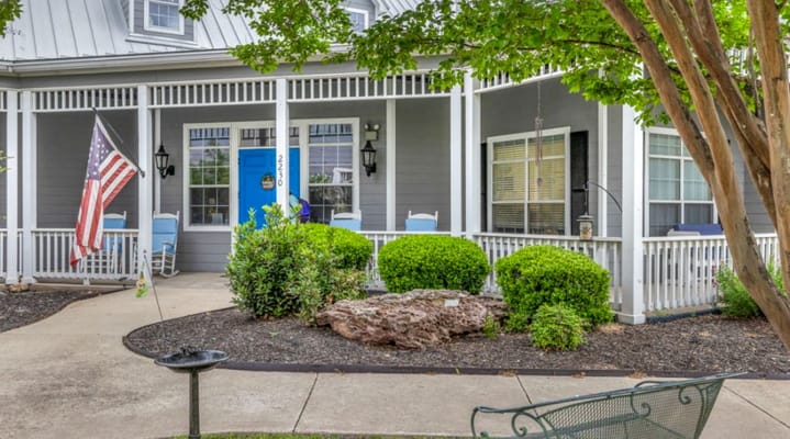 Exterior view of Arbor House with landscaping and porch