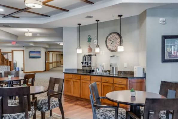 Interior view of a common area with seating and a coffee station