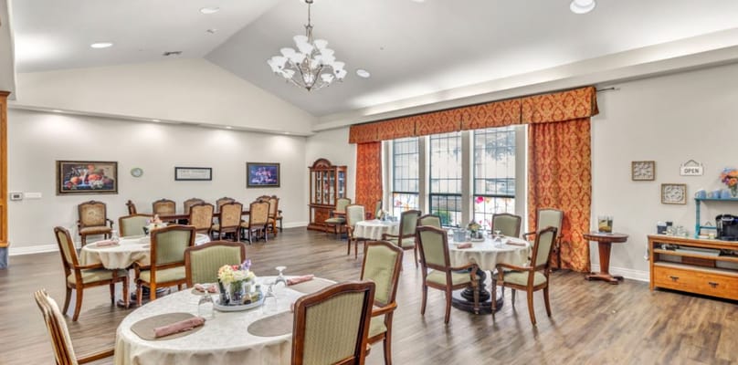 Dining area with tables and chairs in a well-lit room