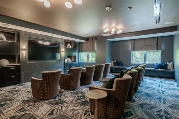 Common area with seating and a large screen