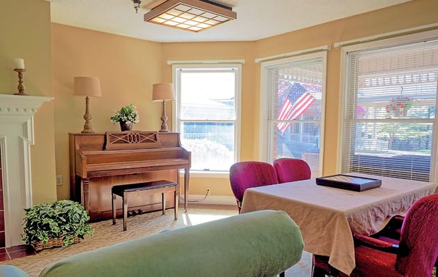 Bright common area with seating and piano