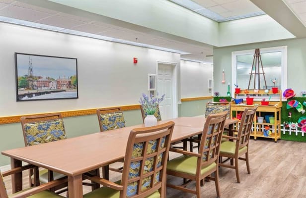 Brightly lit activity room with a wooden table and chairs
