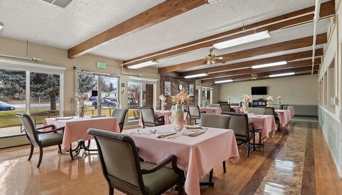 Bright dining room with tables and chairs set for meals
