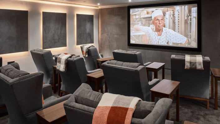 Cozy cinema room with comfortable seating and a movie screen