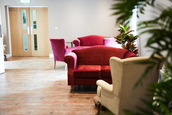 Cozy lounge area with red and cream chairs