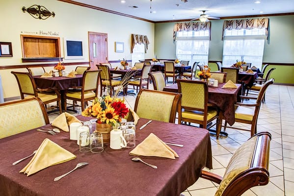 Dining area with set tables and floral centerpieces
