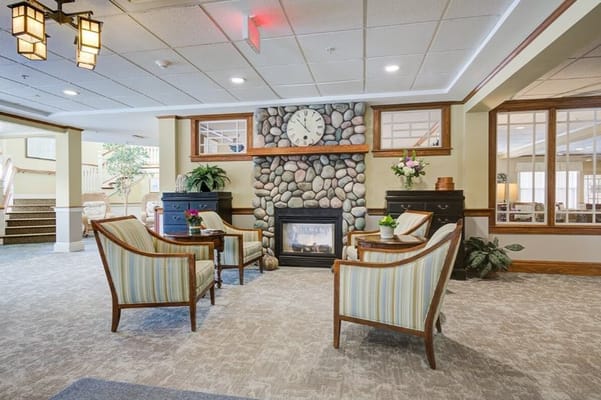 Comfortable seating area with fireplace and decorative stone wall.