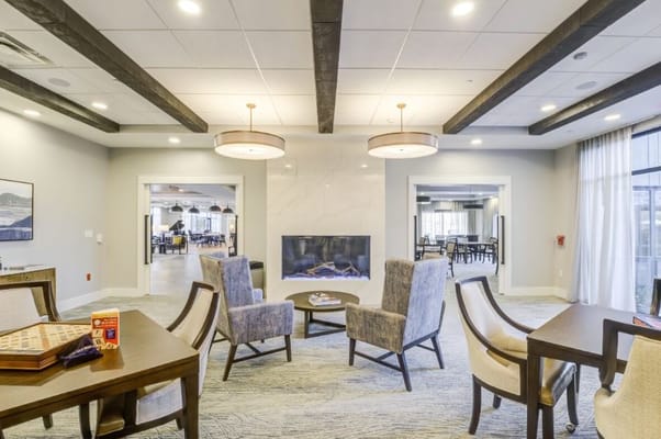 Bright common area with seating and fireplace
