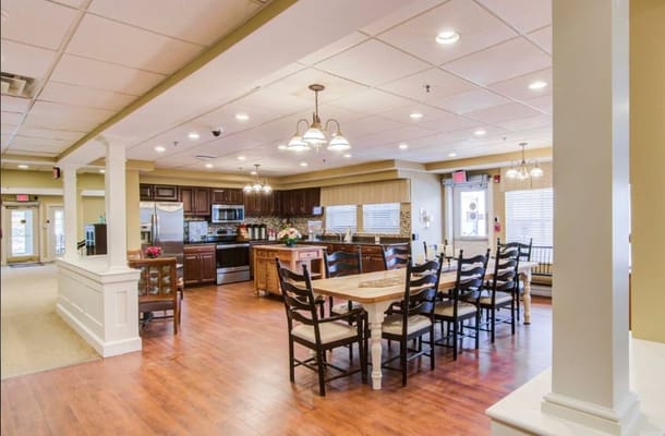 Spacious common area featuring a kitchen and dining table.