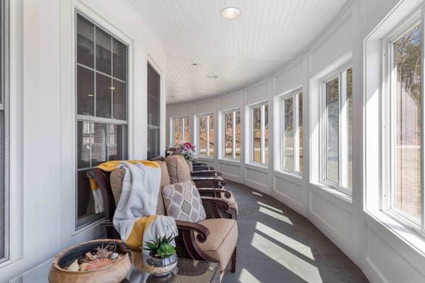 Bright sunroom with comfortable seating and a view of the outdoors
