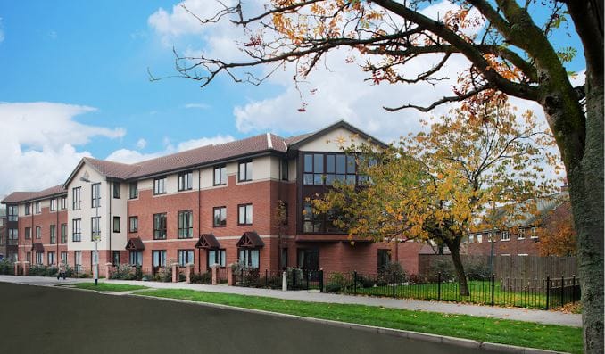 Exterior view of Berkeley House Care Home during autumn