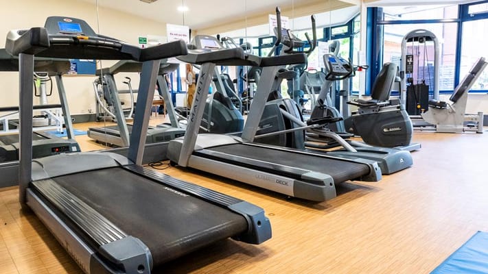 Interior view of gym with treadmills and exercise equipment