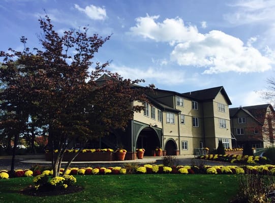 Exterior view of Bertram House with colorful flowers