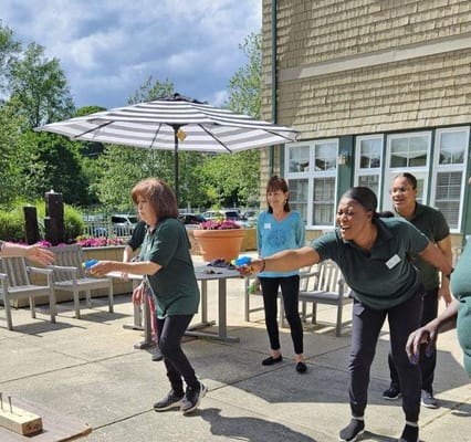 Staff engaging with residents in an outdoor activity