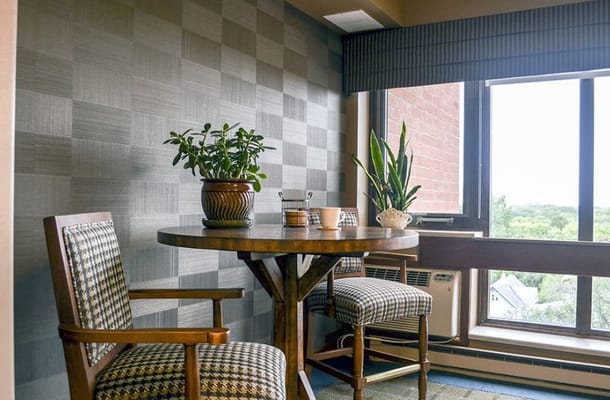 Cozy seating area with plants and a table by the window