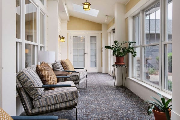 Well-decorated interior hallway with seating and plants