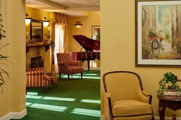 Bright lounge area with elegant seating and a piano