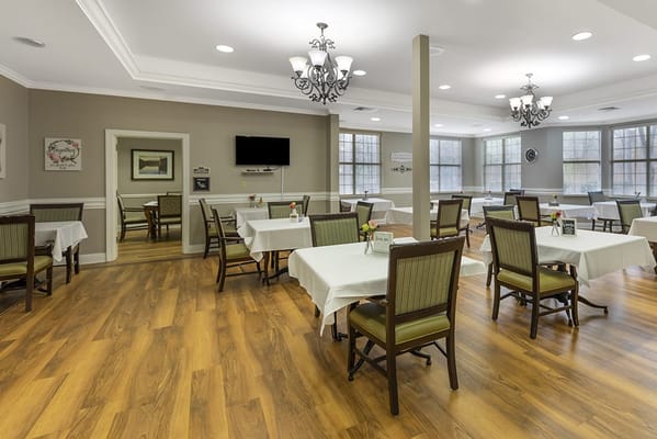 Bright dining room with tables set for meals