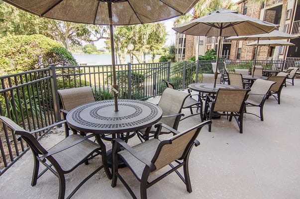 Outdoor seating area by the lake with umbrellas