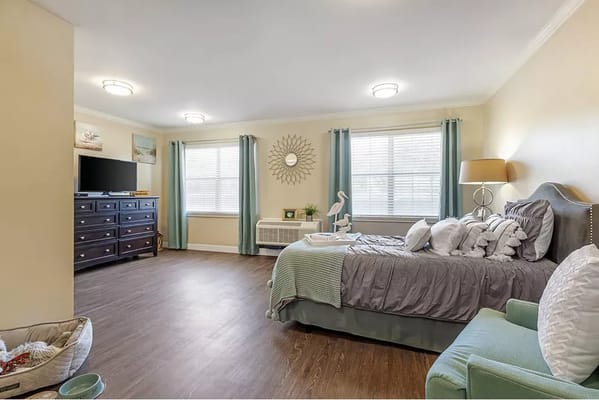 Bright, cozy resident room with a bed and furniture