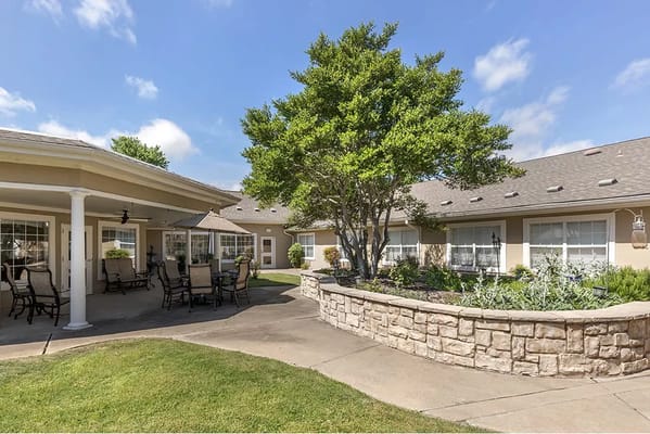 Outdoor patio area with seating and greenery
