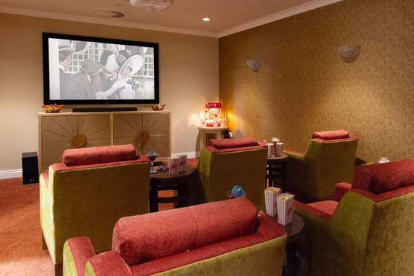 Cozy activity room with plush seating and a large TV