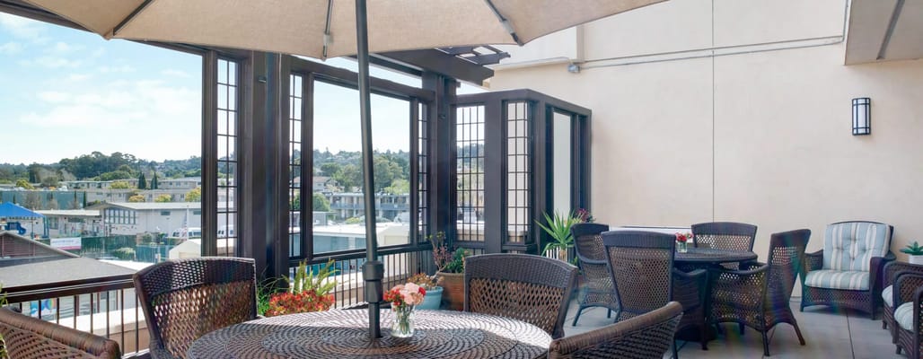 Outdoor patio area with seating and sunny view